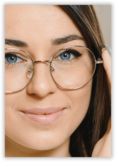 A close up of a woman wearing glasses and smiling