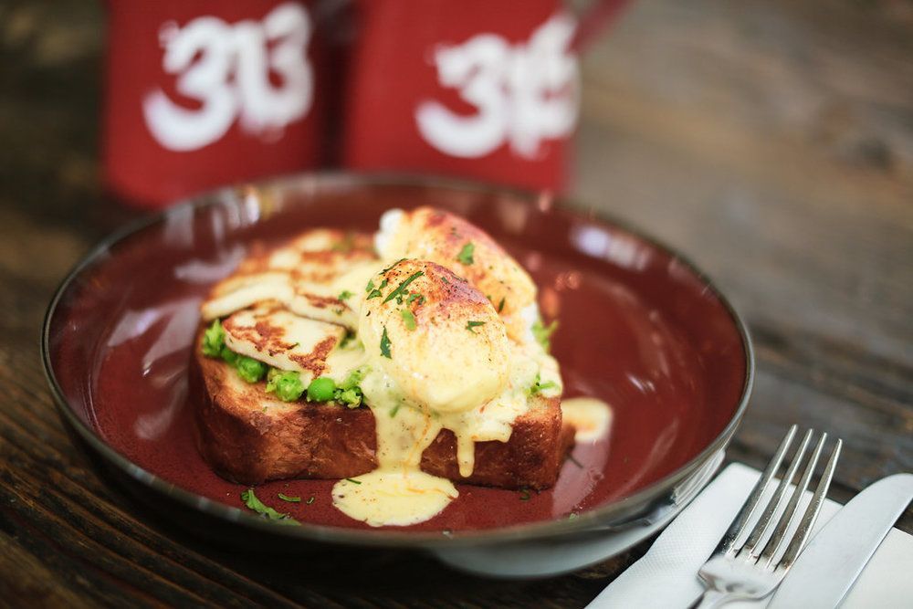 A close up of a plate of food with a fork on a table.