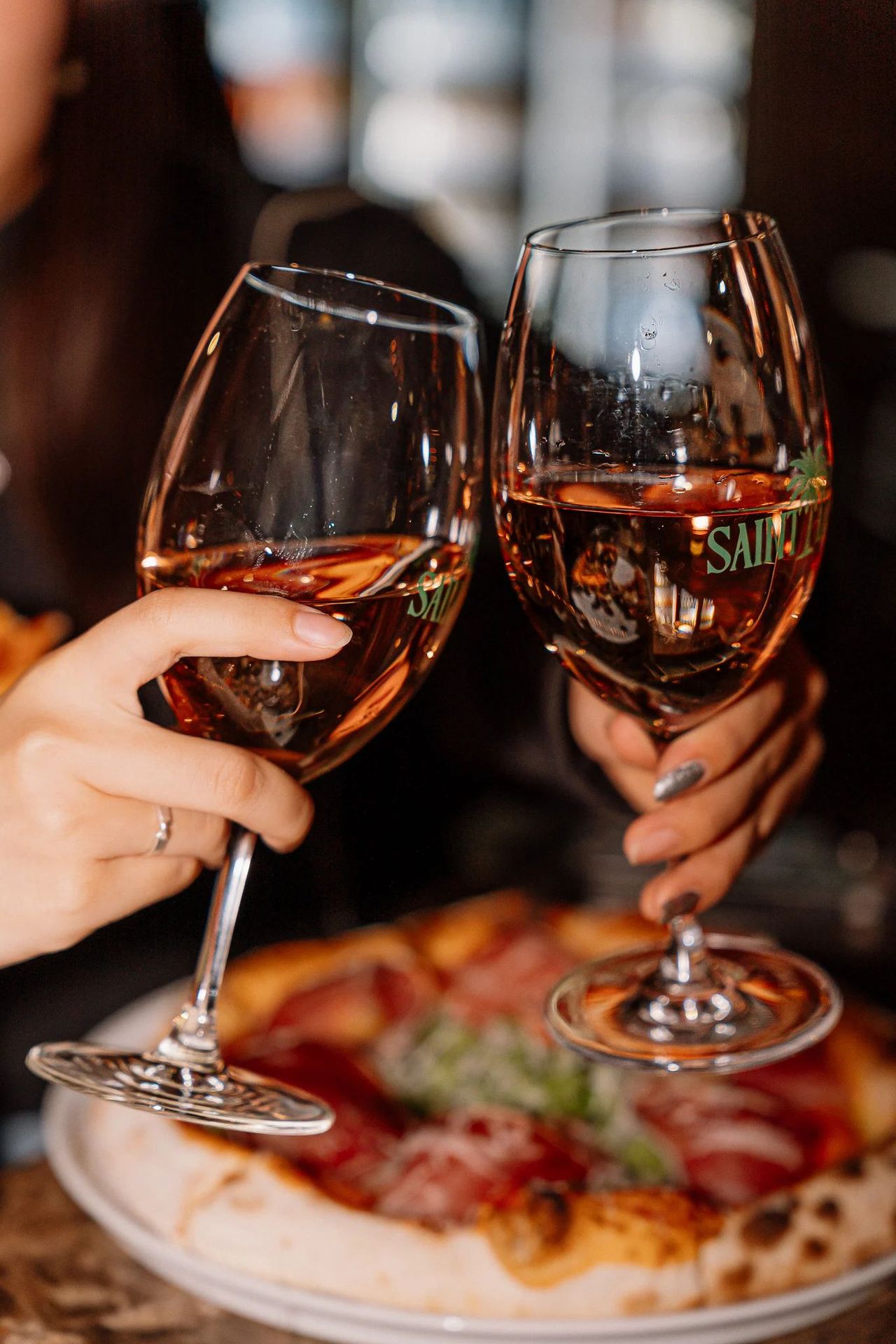 Glasses of rosé over pizza