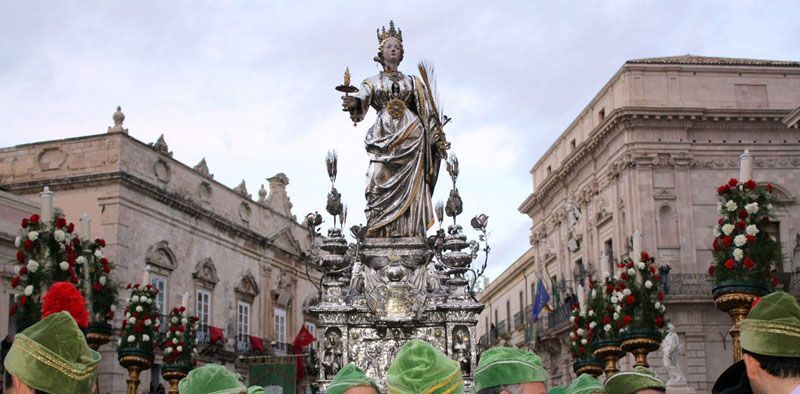 The silver statue of Santa Lucia carried through a piazza in Syracuse, Sicily
