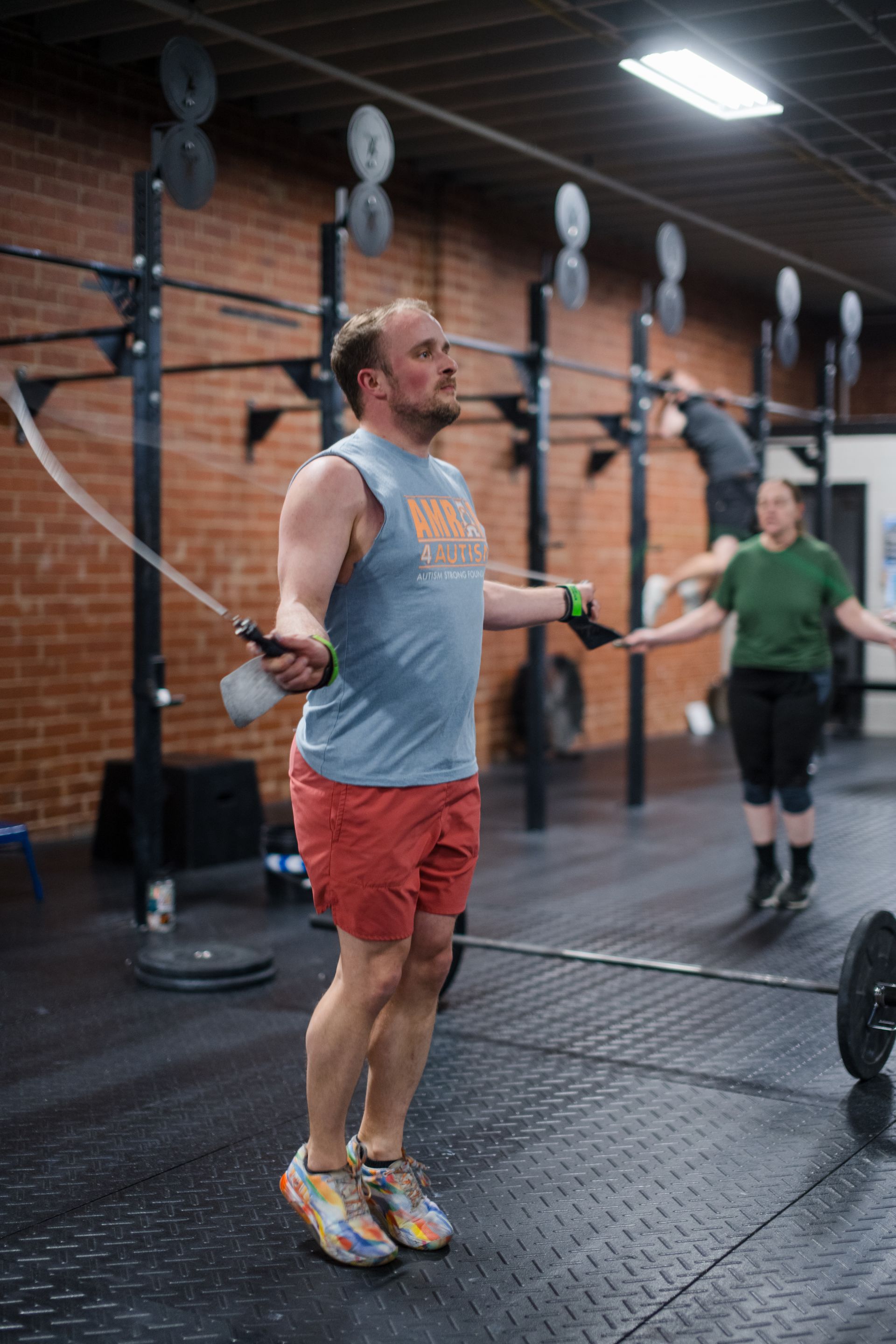 A man is jumping a jump rope in a gym.