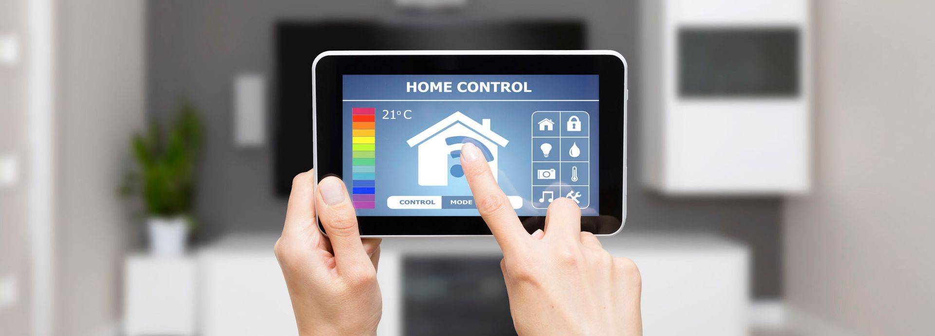 A person is holding a tablet with a home hvac control app on it.