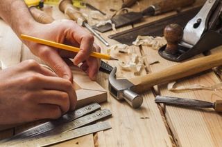 General building contractor holding a pencil and working with wood