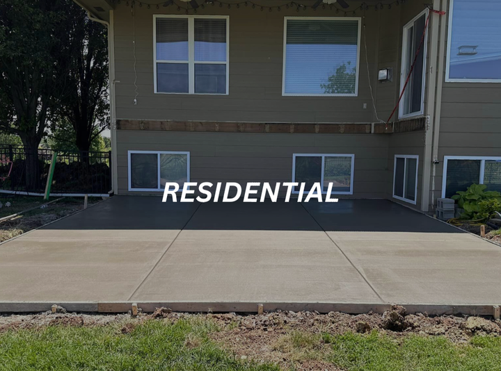 a large house with a concrete patio in front of it .