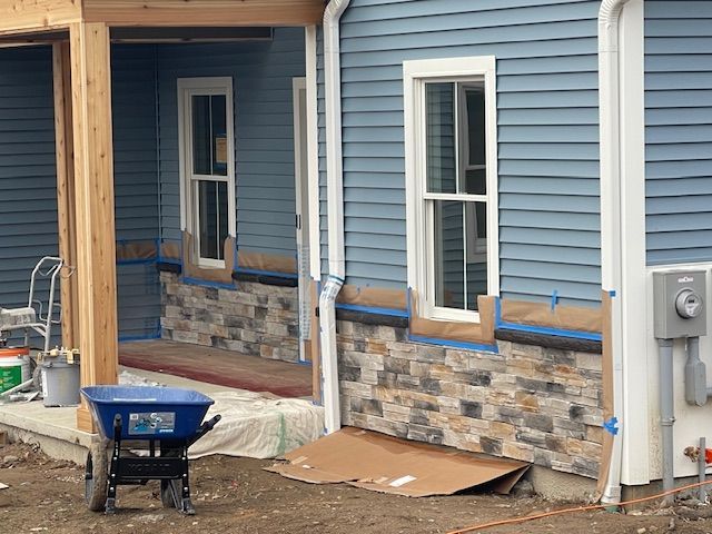 A large house with a lot of windows is being remodeled