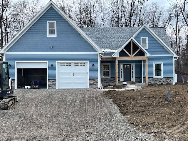 A large house with a lot of windows is being remodeled