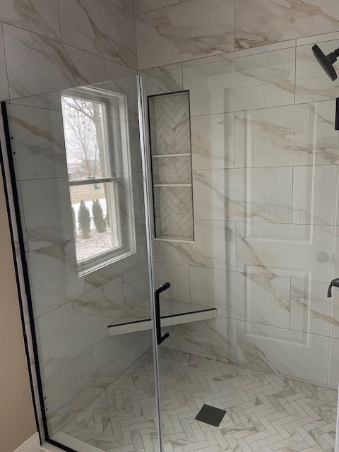 A bathroom is being remodeled with tiles and tools.