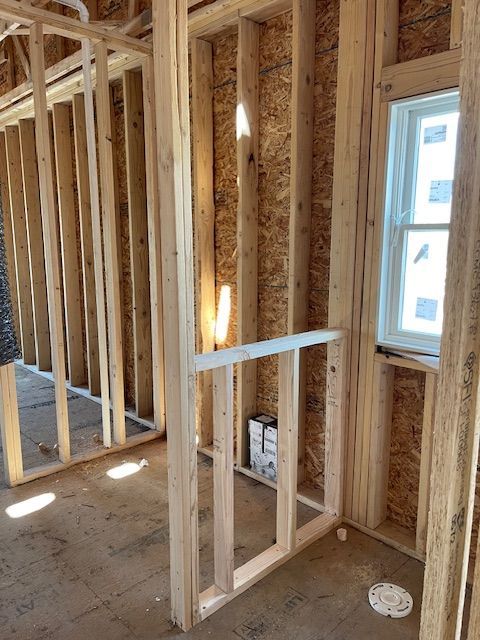 A room that is being built with wooden beams and a window