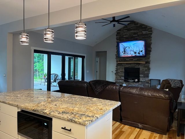 A living room with a couch and a television on the wall.