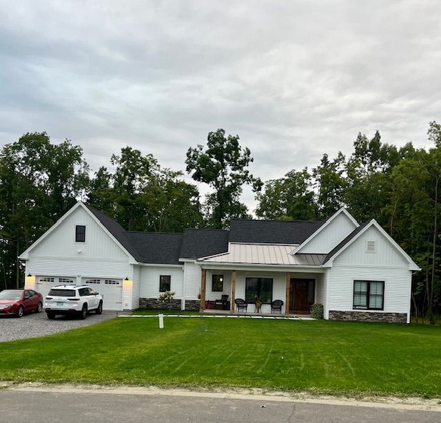 A white house with cars parked in front of it