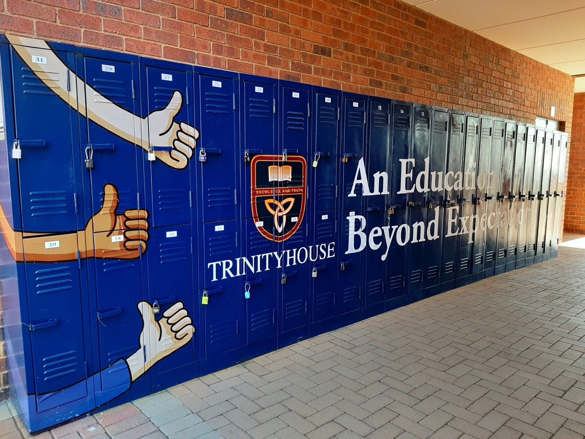 A wall of lockers with a sign that says an education beyond expectations