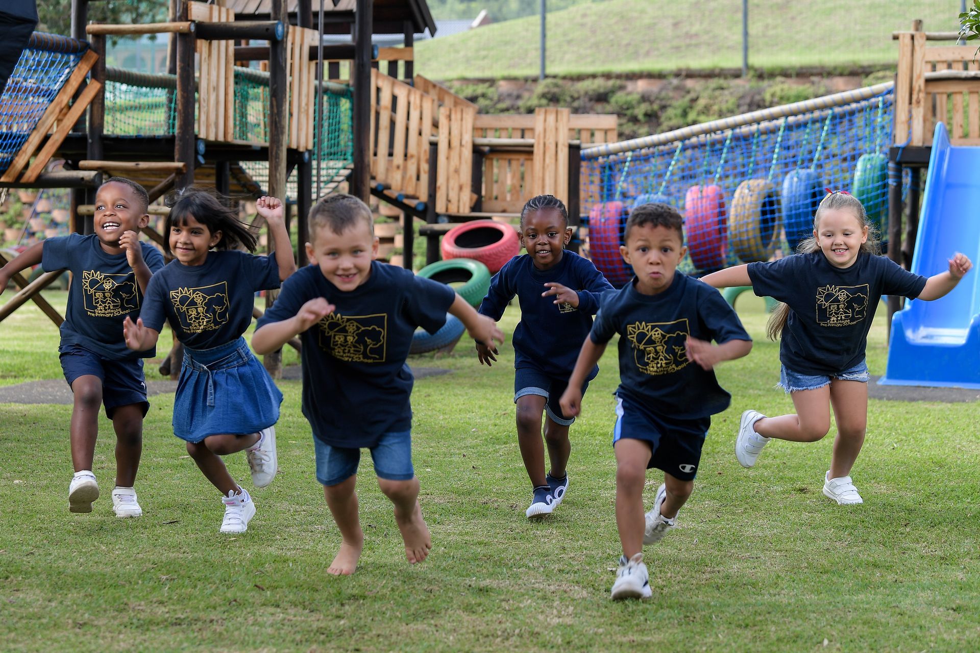 a colorful playground with a slide and a bench in the middle of it .