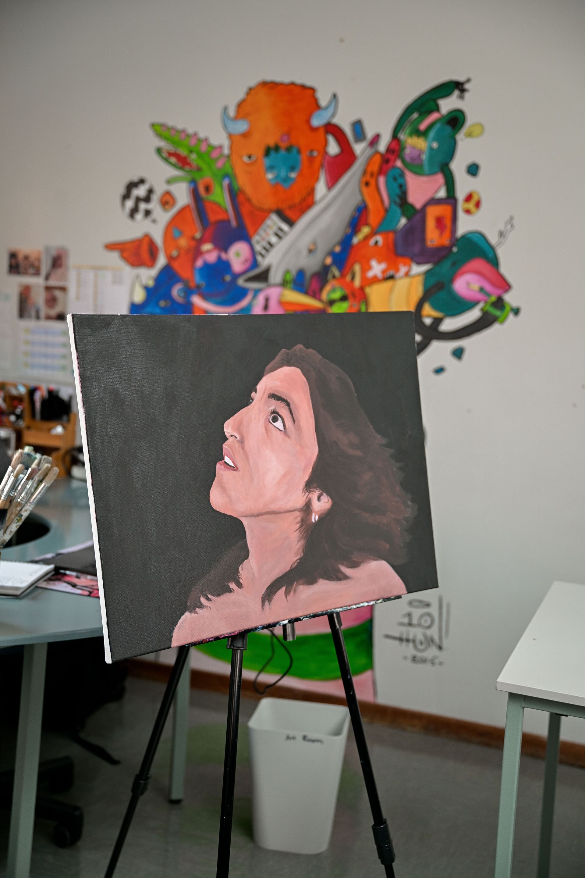 a group of children are sitting at computers in a classroom .