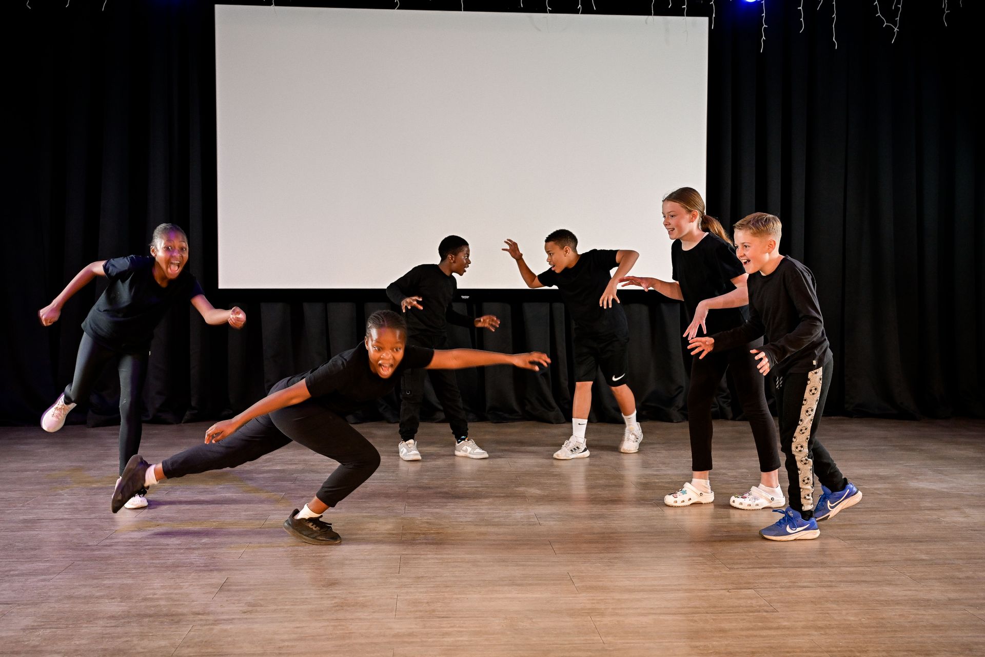 a boy in a white shirt and tie is using a screwdriver on a piece of paper .