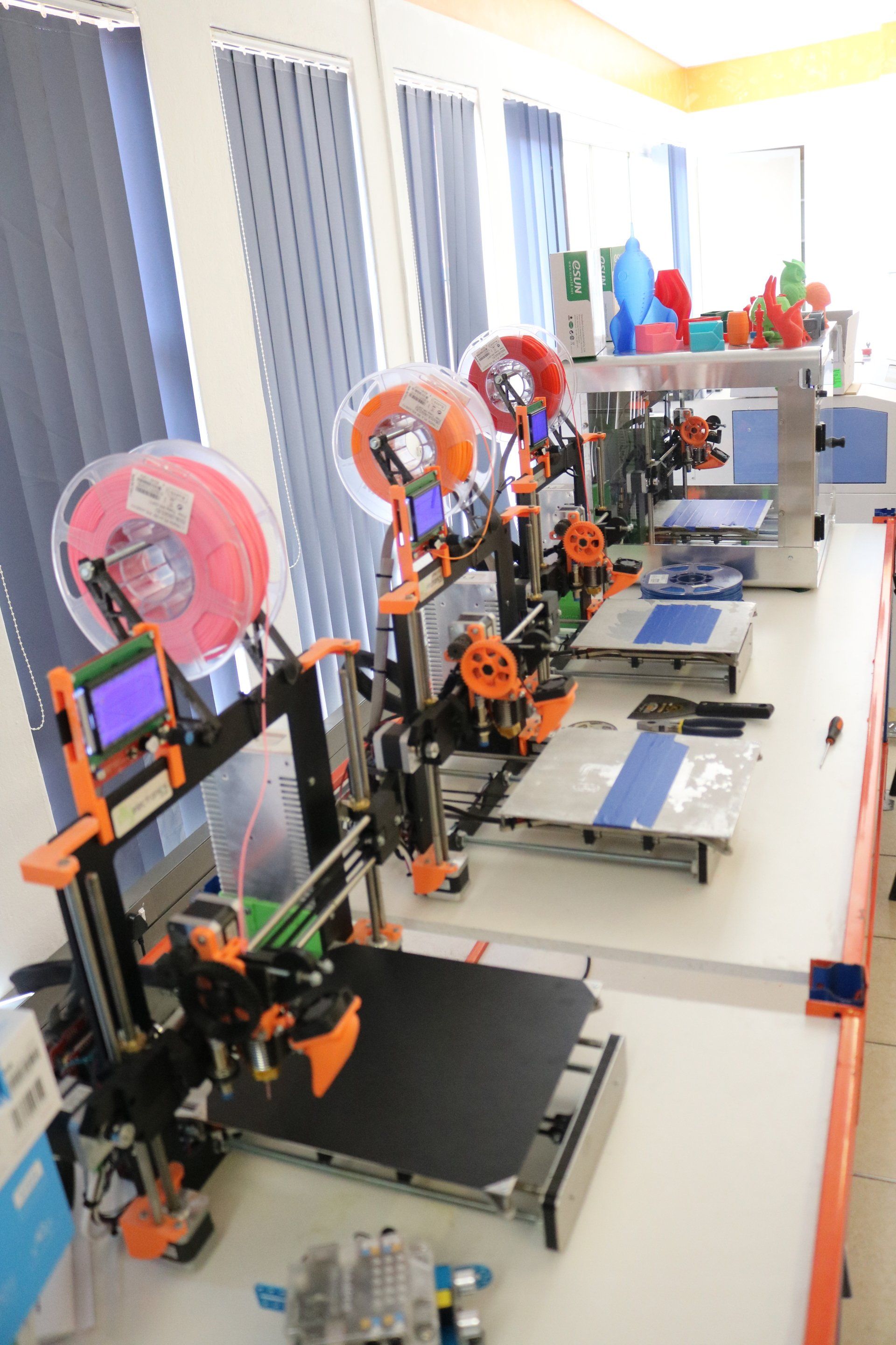 a row of 3d printers are lined up on a table