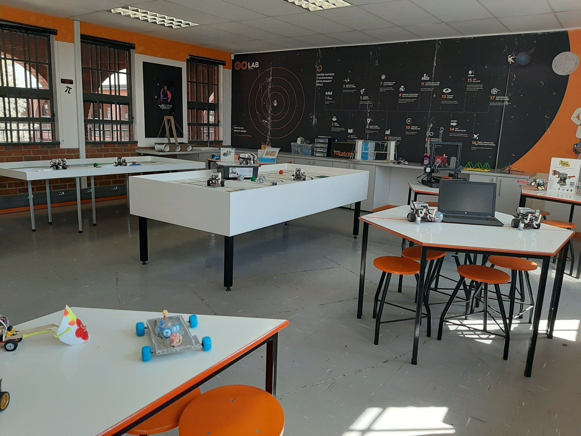 a robotics lab with lots of tables and chairs