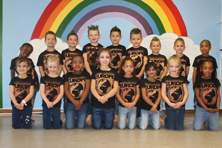A group of children wearing europe shirts pose for a picture