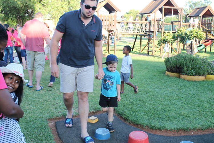 A man and a child are playing a game in a park