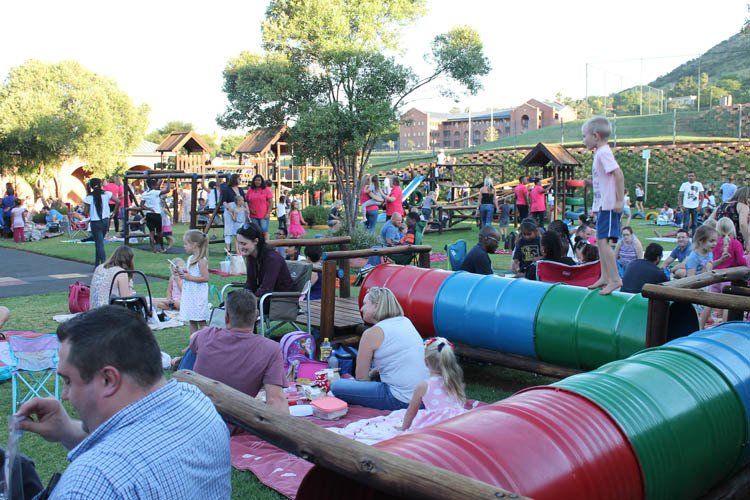 A group of people are having a picnic in a park.
