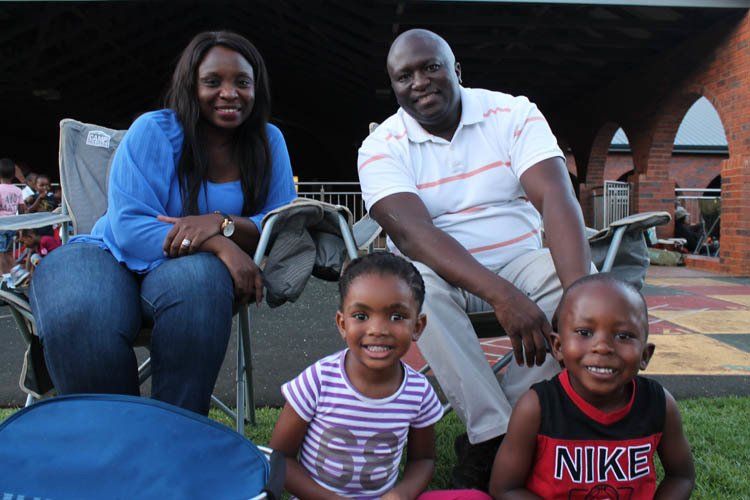 A family posing for a picture with one child wearing a nike shirt