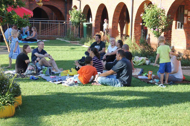 A group of people are having a picnic in the grass