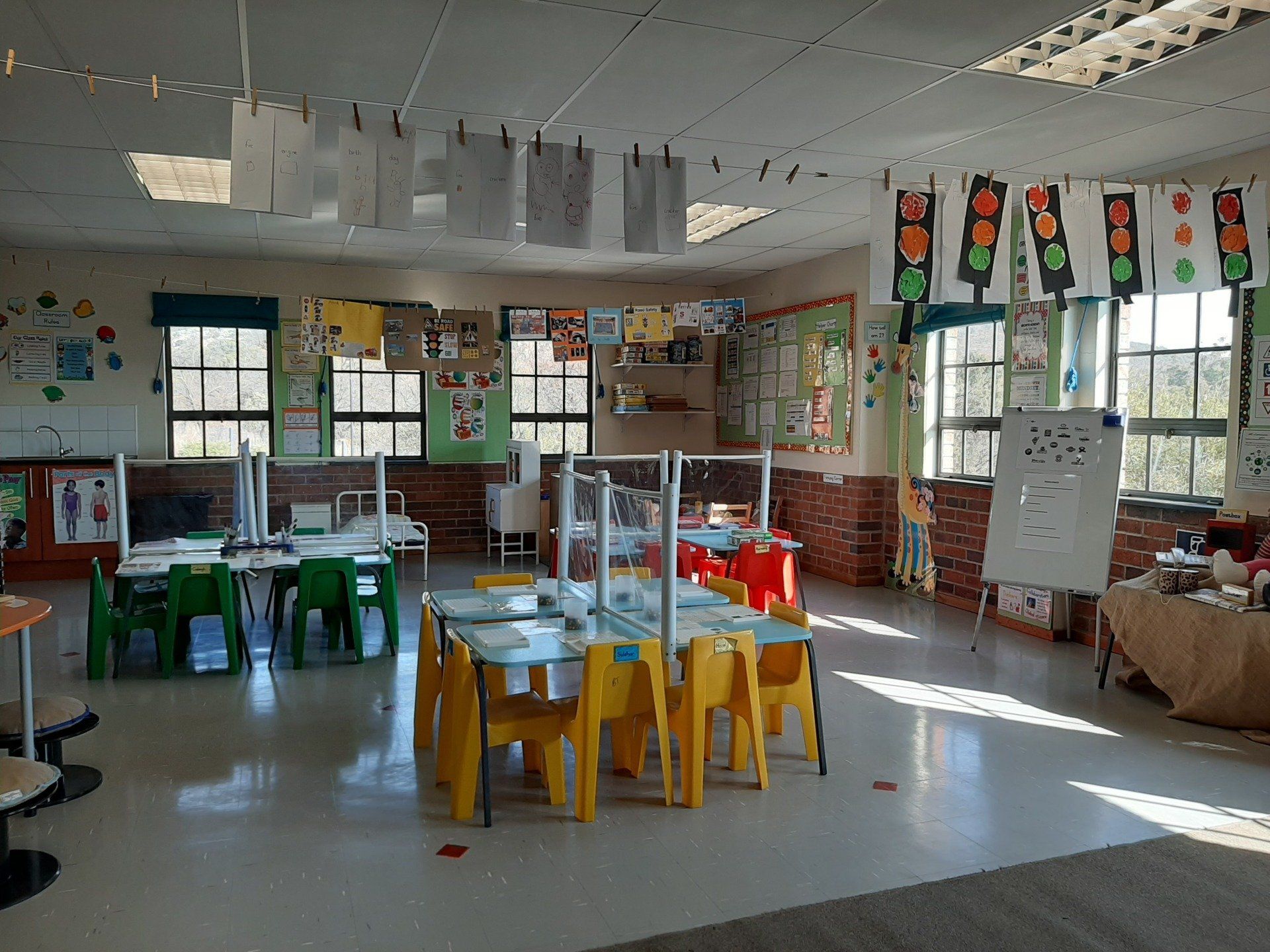 a large classroom with tables and chairs and a lot of windows .