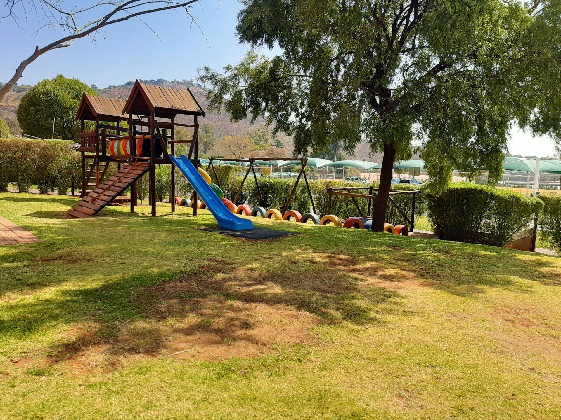 a playground with a slide and swings.