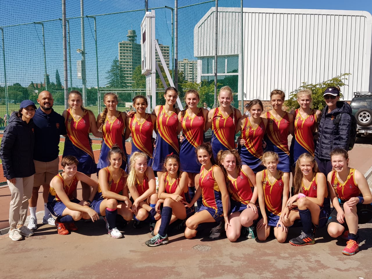 A group of young girls are posing for a picture on a field.