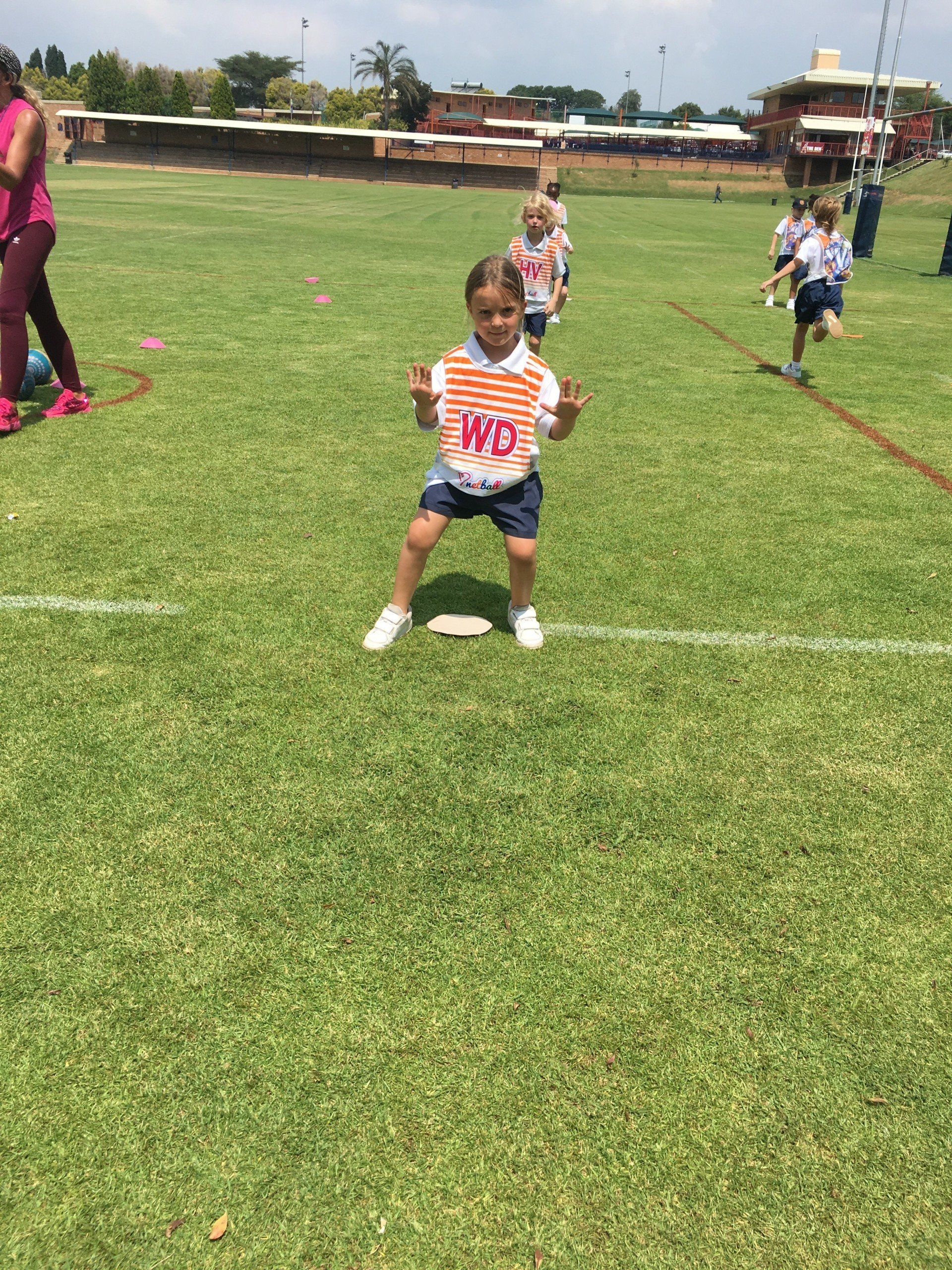 A group of children are playing on a soccer field.