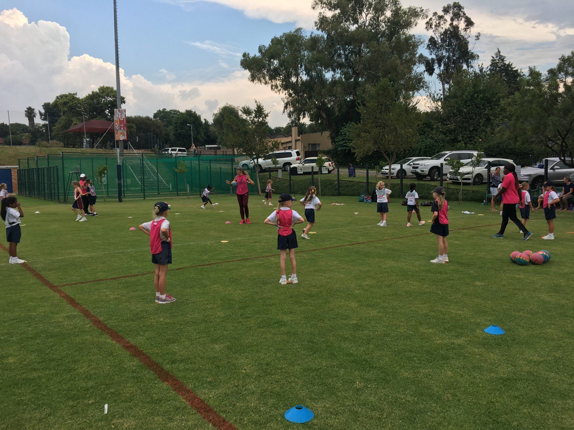 A group of children are playing on a grassy field.