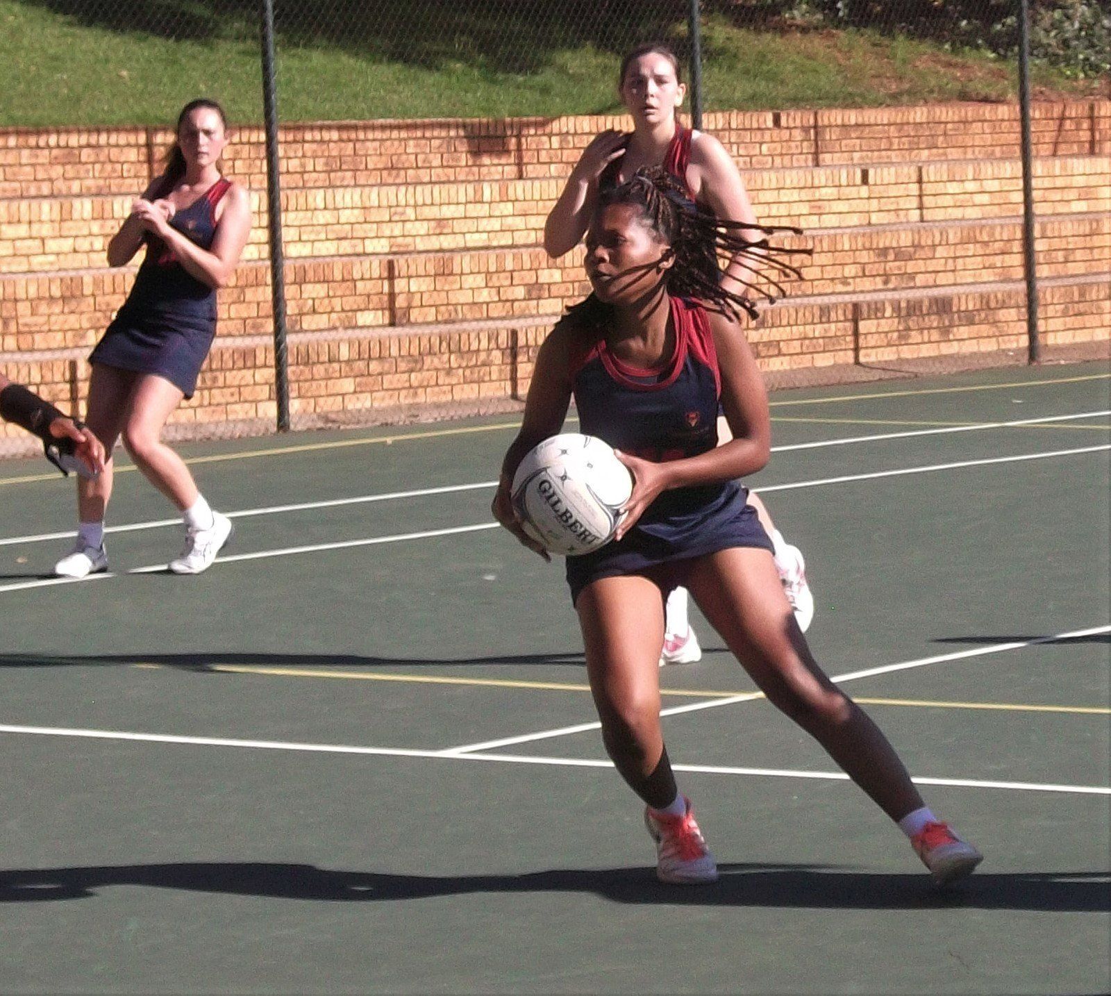 A woman holding a ball that says ' reebok ' on it