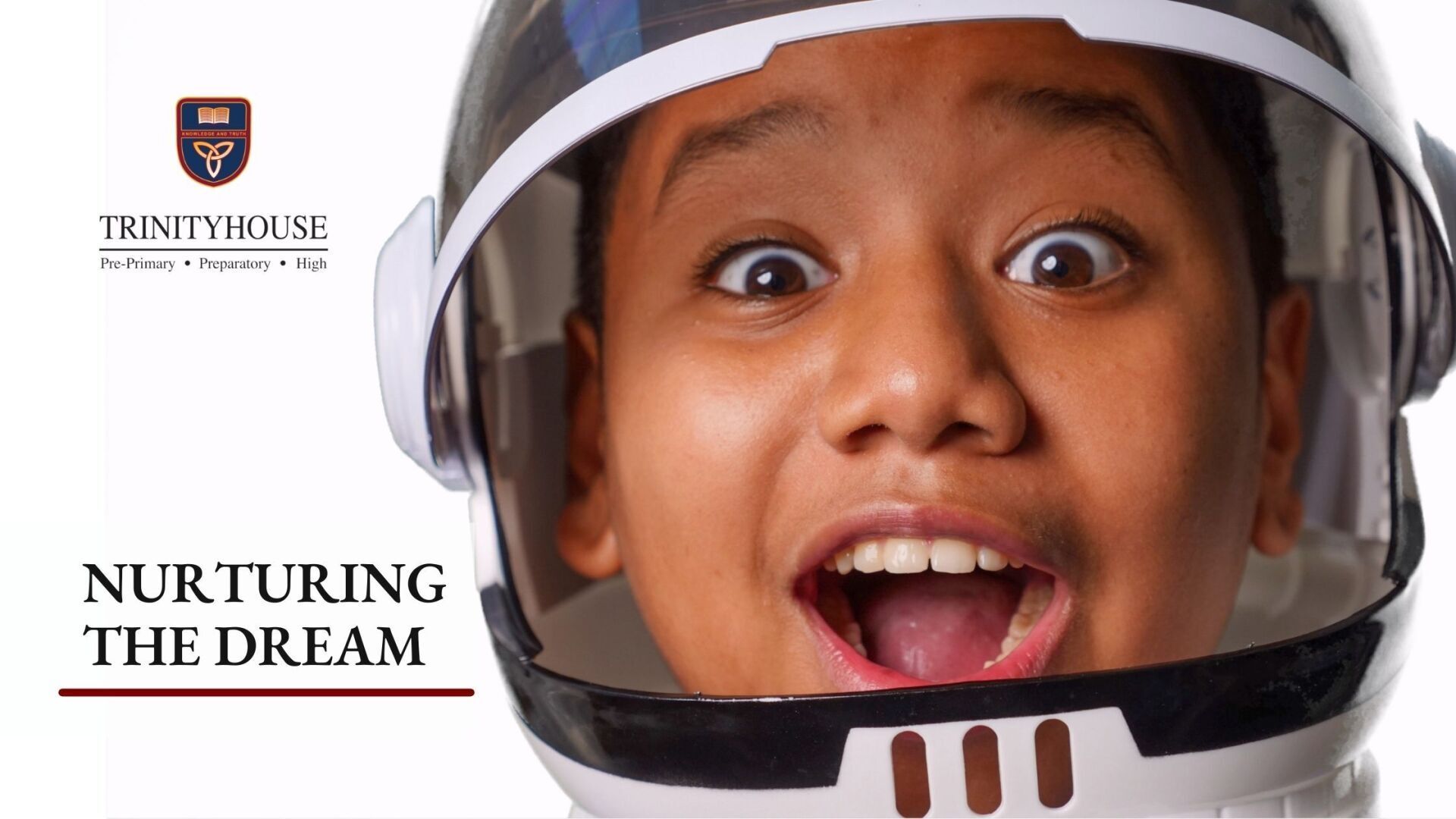 Boy with mouth open with space helmet, his dream career