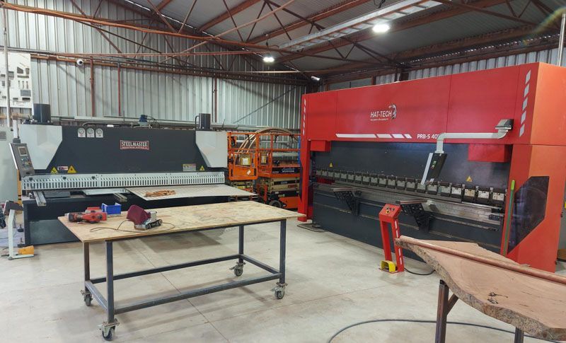 A red guillotine folder in the workshop