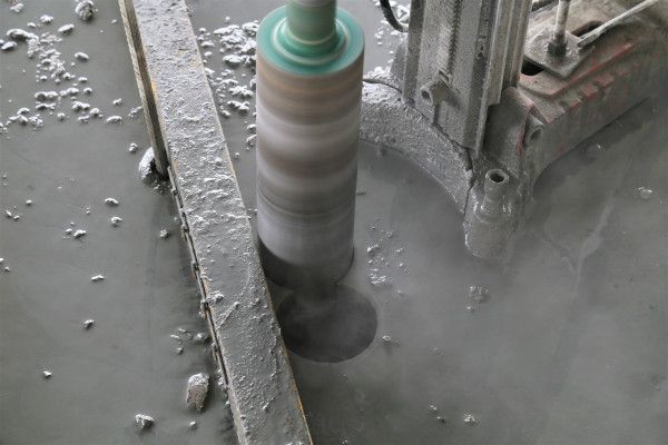 A machine is cutting a hole in a concrete surface.