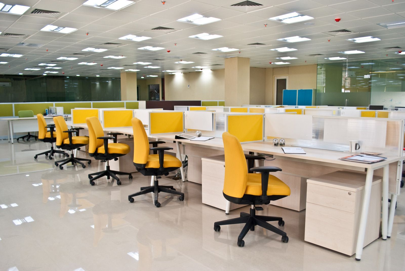 A large office with a lot of desks and chairs.