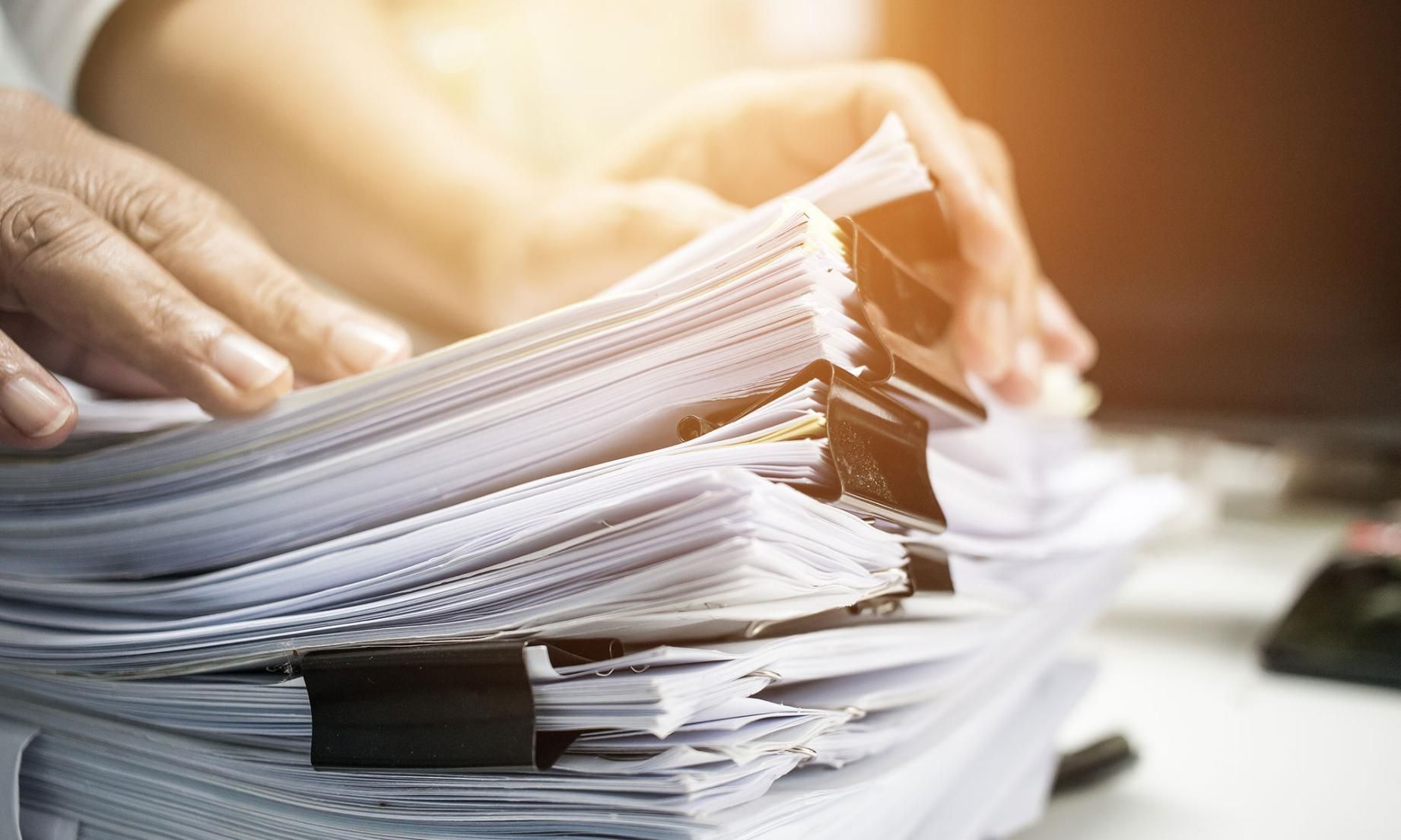 Person is Holding a Stack of Papers in Their Hands — Copy That @ Profsec in Ballina, NSW