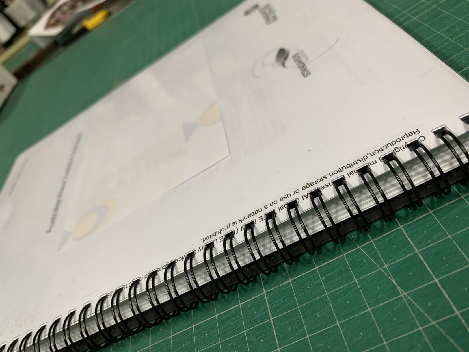Spiral Bound Notebook is Laying on a Green Cutting Mat — Copy That @ Profsec in Ballina, NSW