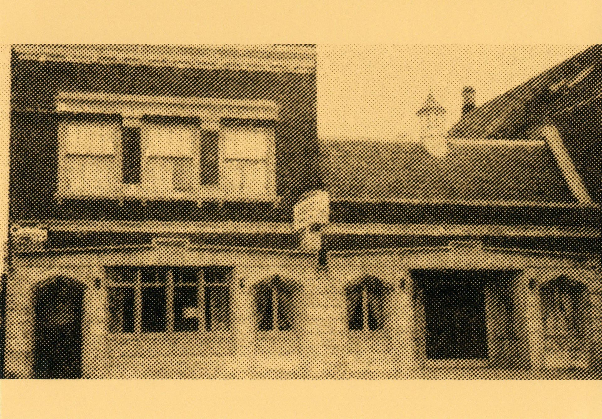Building exterior with arched windows and brick facade.