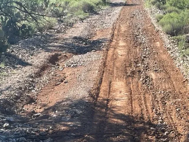 A dirt road with a lot of tire tracks on it