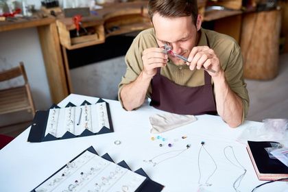 Man Appraising Jewelry In Shop — Roanoke, VA — Roanoke Pawn