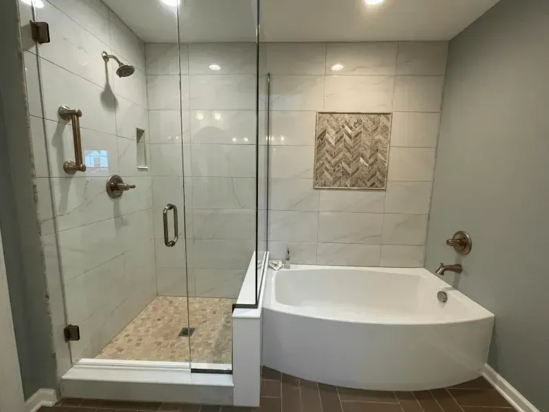Modern bathroom with glass shower, soaking tub, and tile walls.