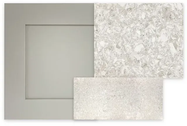 Gray cabinet door sample, speckled countertop, and textured tile sample against a white background.