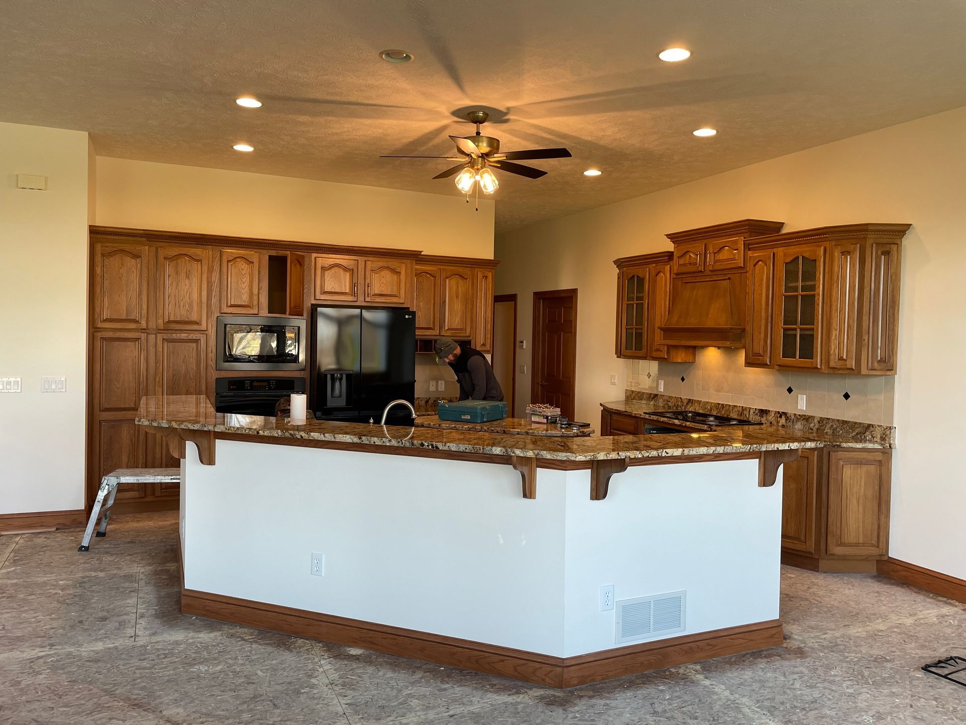 Kitchen remodel: Island with granite countertop, cabinets, and appliances.