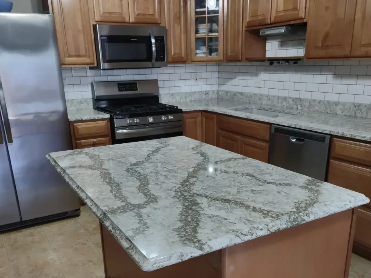 Luxurious bathroom with dark stone shower, glass door, and white bathtub.