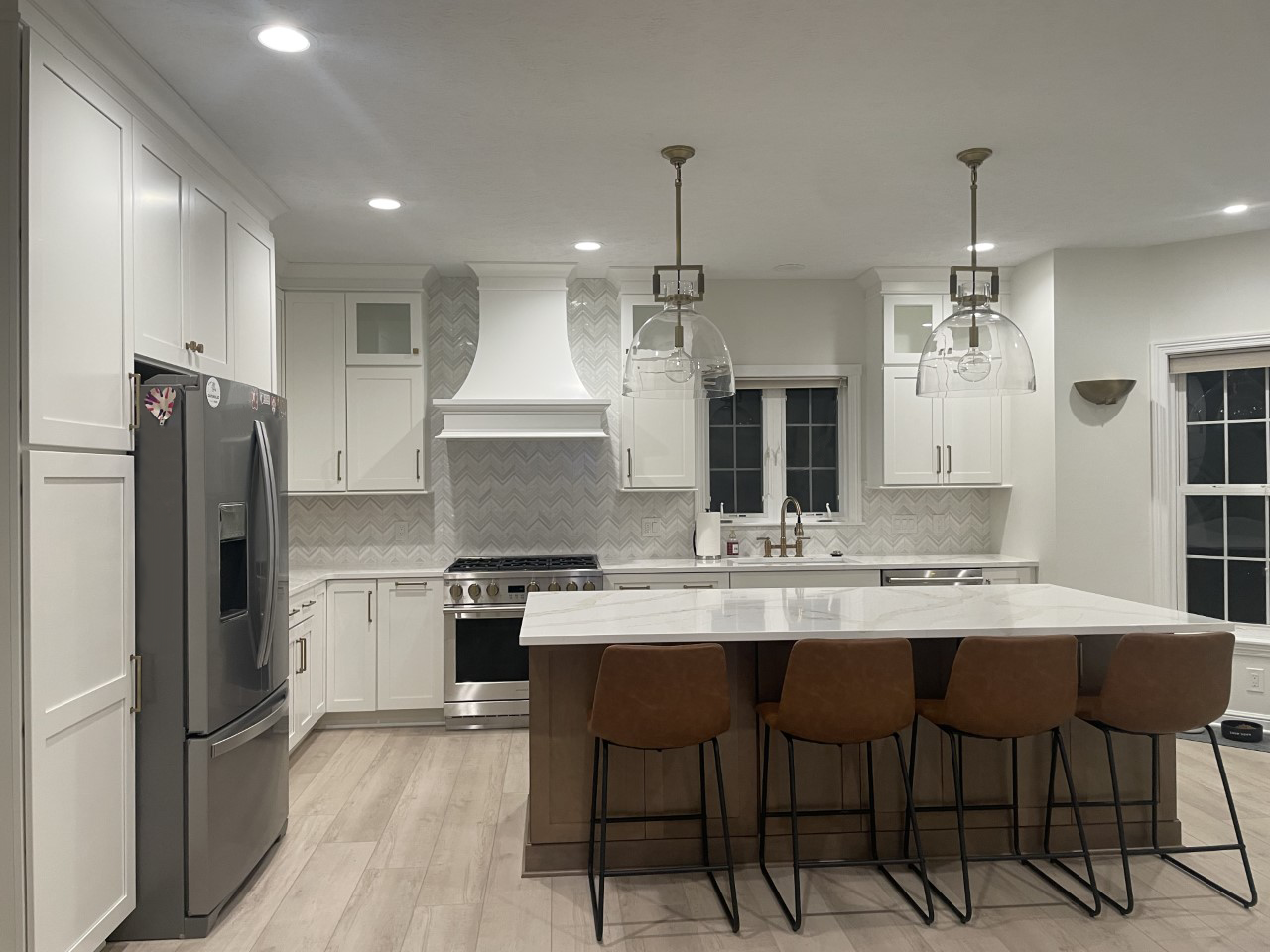 Luxurious bathroom with dark stone shower, glass door, and white bathtub.