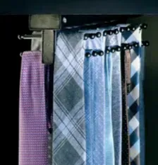 A tie rack with various patterned ties, attached to a dark cabinet.