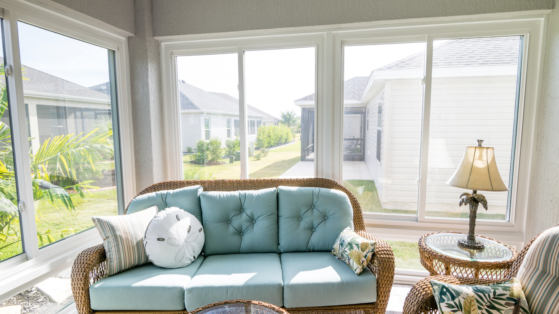 A living room with a blue couch and a lamp