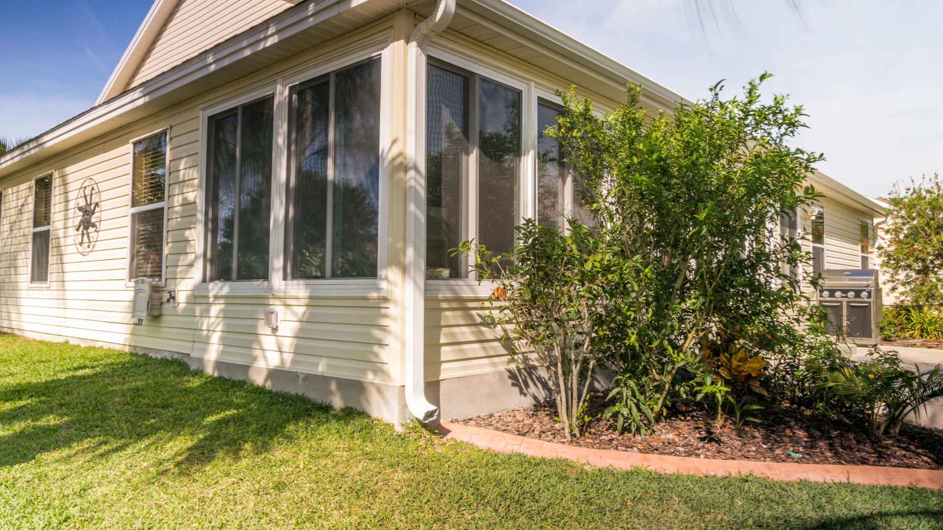 A house with a screened in porch and many windows