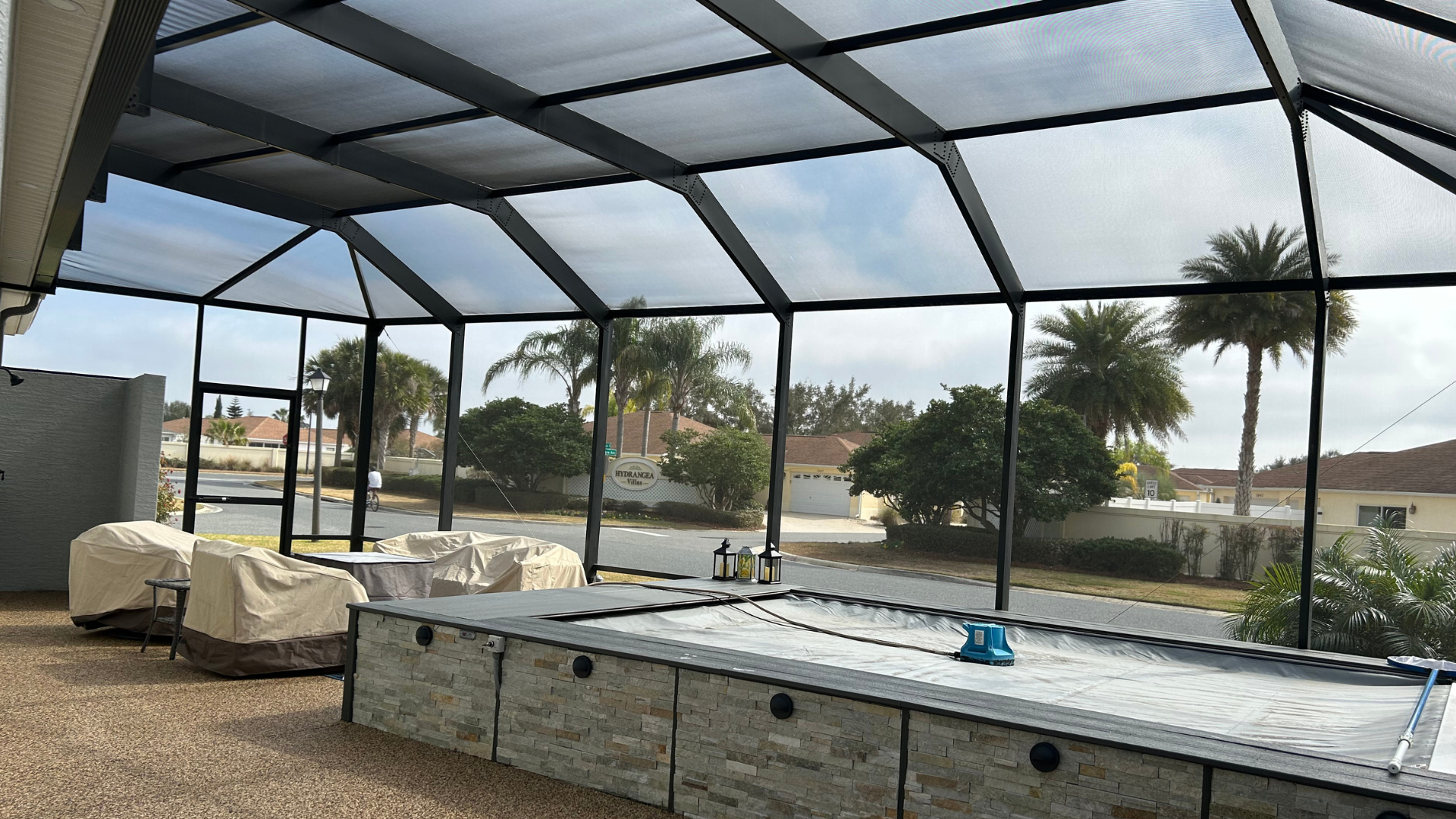 A screened in area with a table and chairs