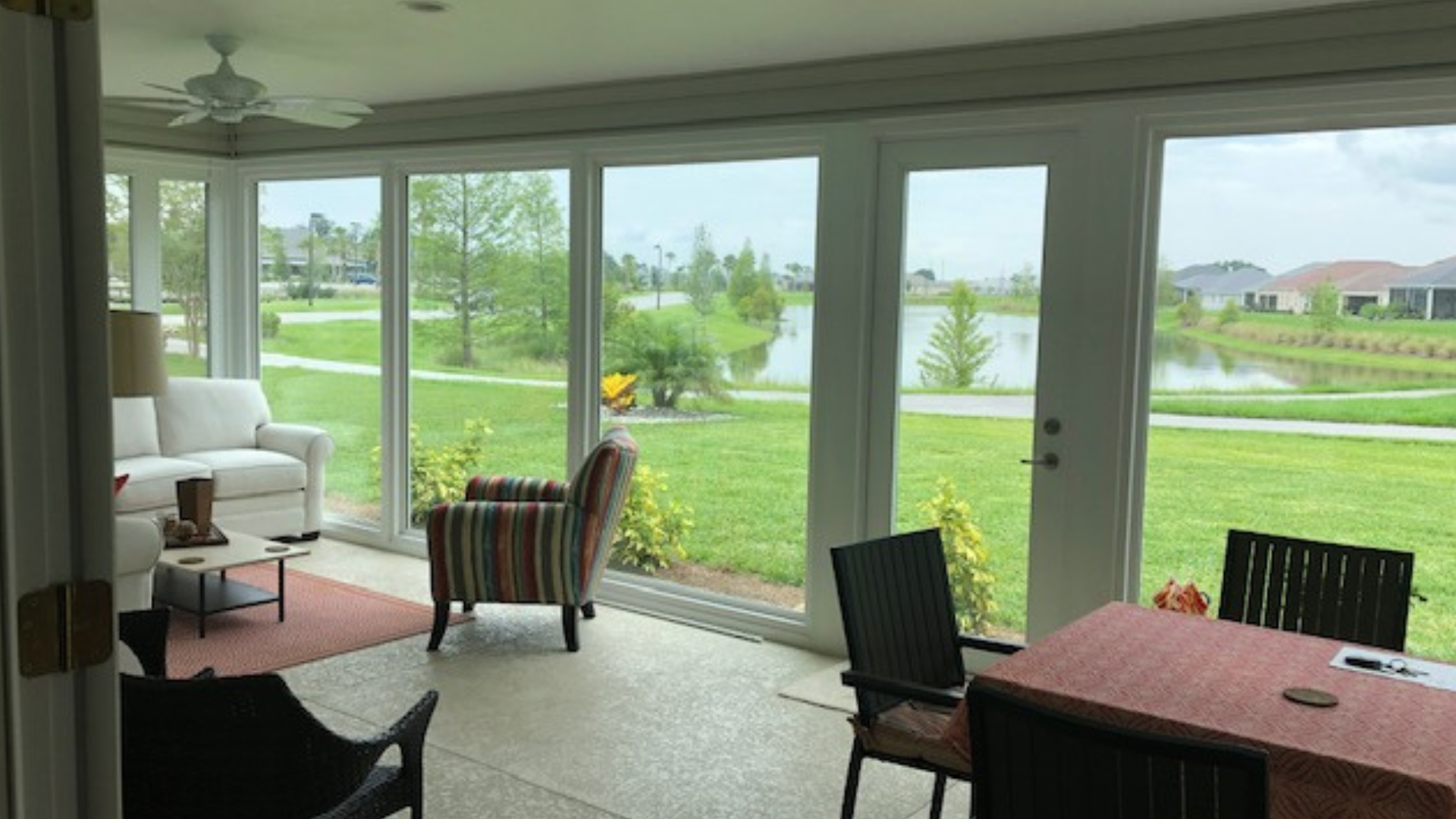 A living room with a couch and chairs and a table